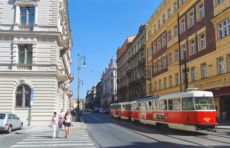 14 - A classic red-and-white Tatra T3 tram operating on a historic urban street in Prague